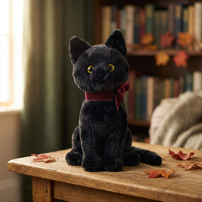 Peluche di gatto nero seduto con fiocco e coda bordeaux