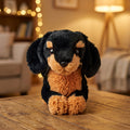 Peluche cane bassotto nero focato in posizione sdraiata